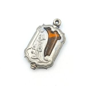 Antique Art Nouveau silver tone floral fob with amber glass insert